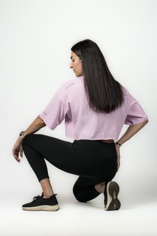 Elev8 lilac oversized crop tee crouching pose — womens fitness apparel SA